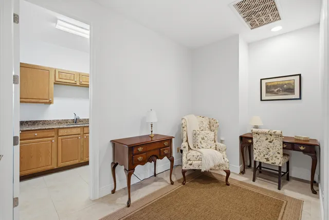 an aerial view of residential houses with outdoor space and trees