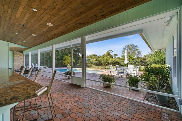 an aerial view of a house with a swimming pool outdoor seating and yard