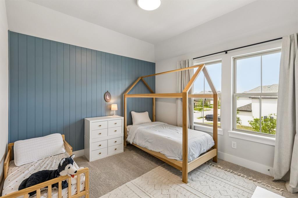 3004 Windy Rdg Road McKinney, TX 75071 - Photo 26 of 40 a bedroom with a bed and a window