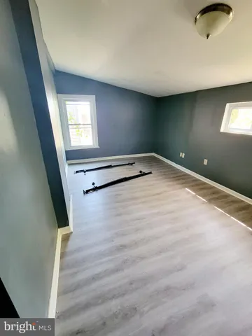 a view of a room with wooden floor and windows