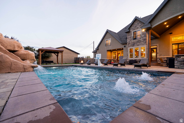 687 South 2080th Street East Springville, UT 84663 - Photo 135 of 149 Outdoor swimming pool featuring a rock waterfall, water fountains, and paved surround