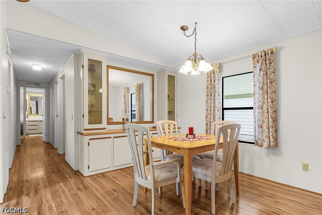 5 Erica Street Alva, FL 33920 - Photo 20 of 37 a dining room with furniture and wooden floor