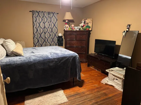 a bedroom with a bed and a television