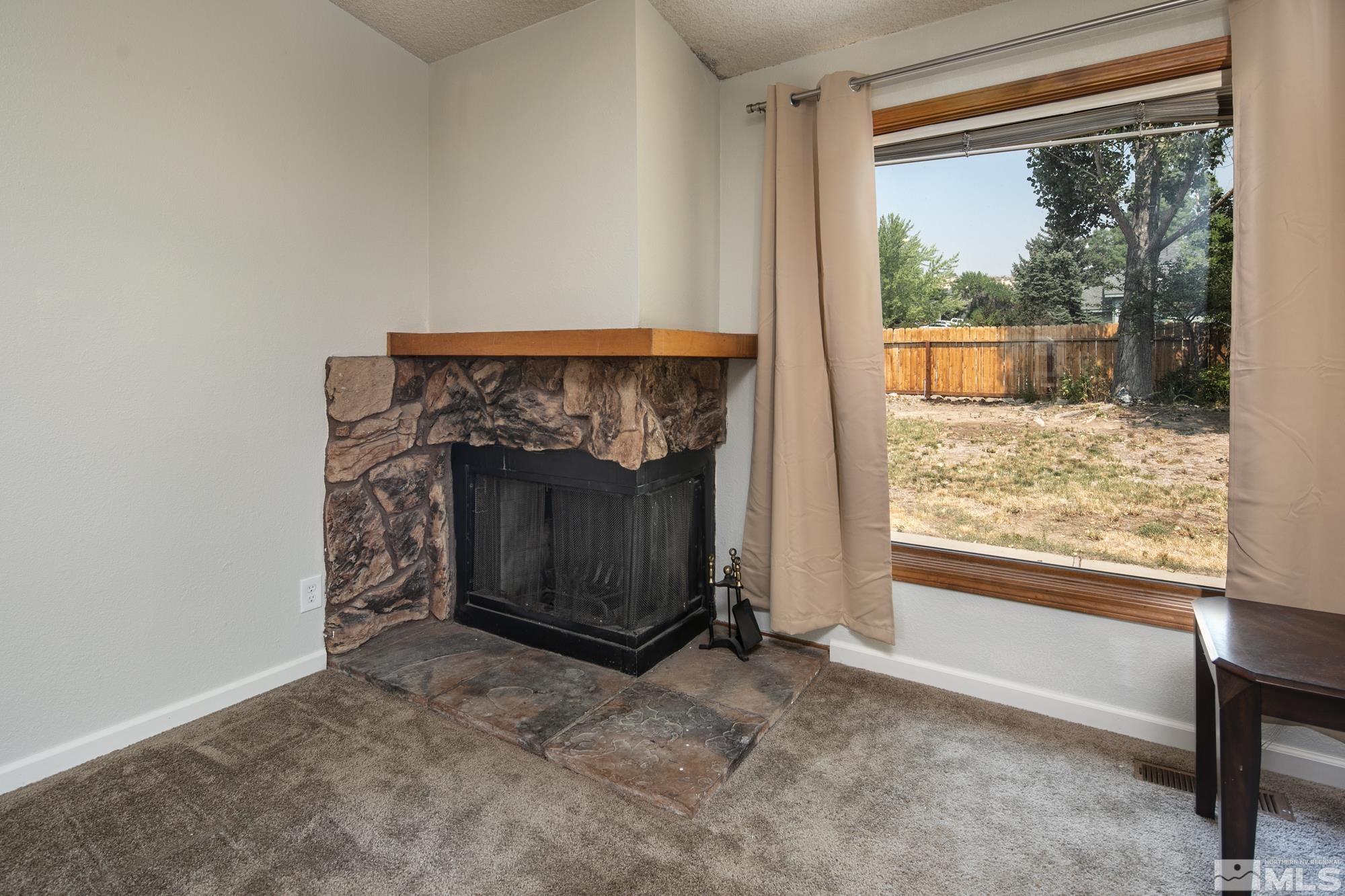 5335 Seville Court Reno, NV 89523 - Photo 15 of 31 a view of an empty room with a fireplace and a window