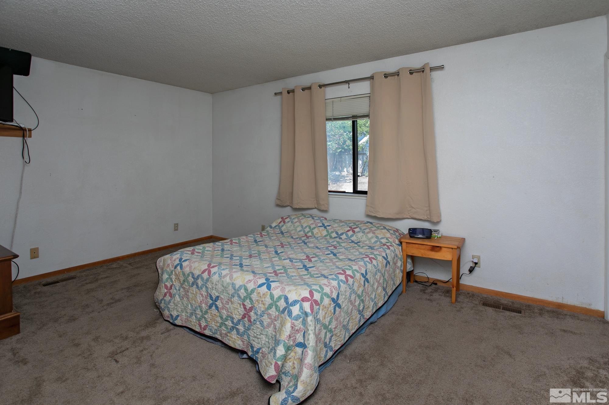 5335 Seville Court Reno, NV 89523 - Photo 21 of 31 a bedroom with a bed and a window