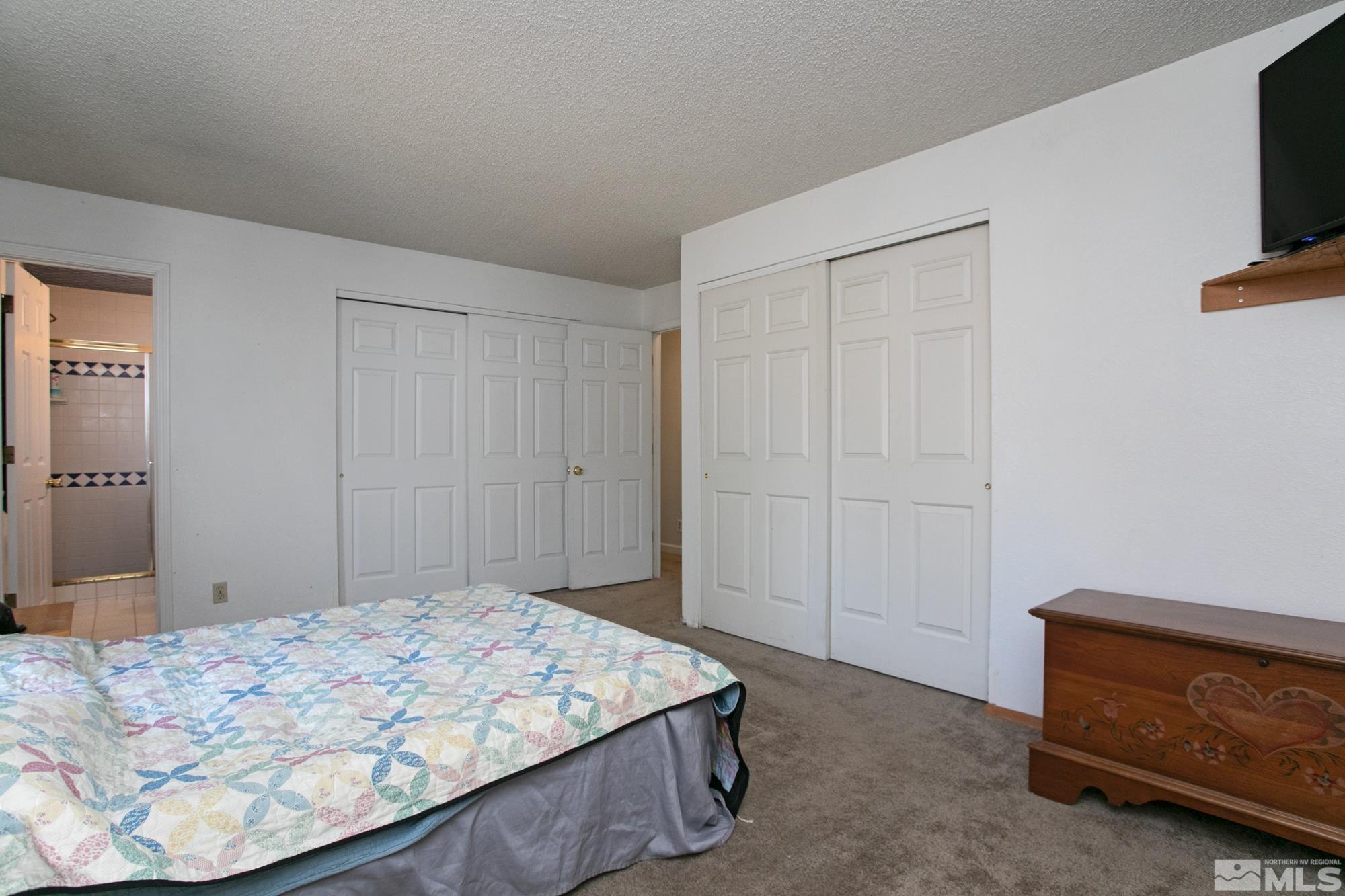 5335 Seville Court Reno, NV 89523 - Photo 22 of 31 a bedroom with a bed and a tv in it