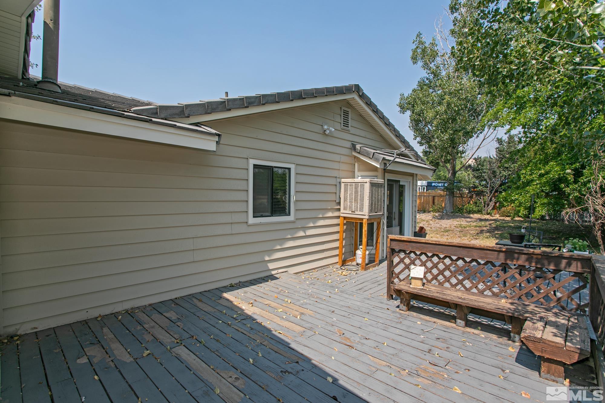 5335 Seville Court Reno, NV 89523 - Photo 26 of 31 a view of a roof deck with wooden floor and fence and a floor to ceiling window