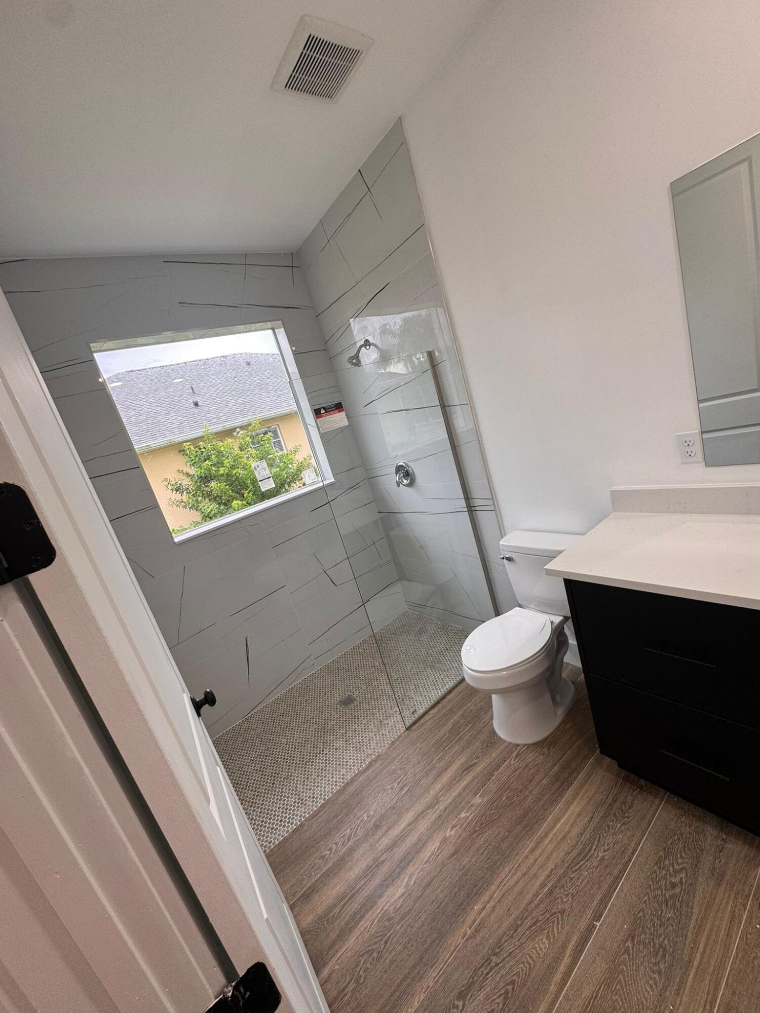 500 Sunset Road North Rotonda West, FL 33947 - Photo 15 of 25 a bathroom with a sink mirror vanity and toilet