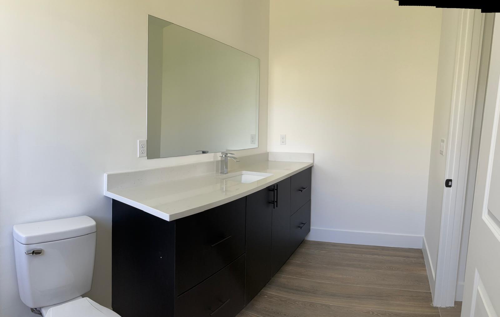 500 Sunset Road North Rotonda West, FL 33947 - Photo 16 of 25 a bathroom with a sink vanity and a toilet