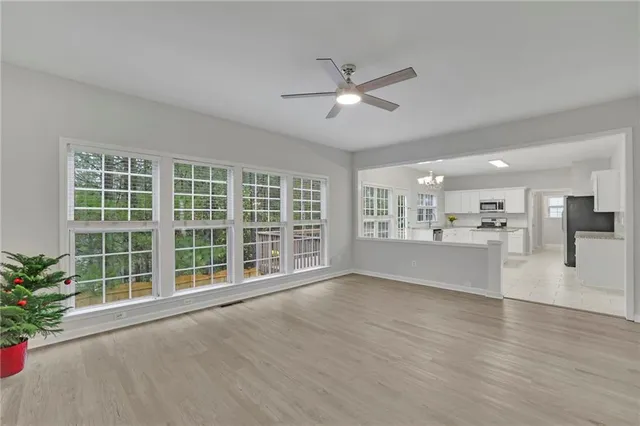 a kitchen with stainless steel appliances granite countertop a sink counter space cabinets and a window