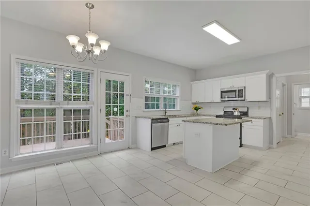 a kitchen with granite countertop a sink stove and cabinets