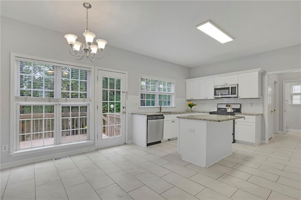 11420 Crossington Road Alpharetta, GA 30005 - Photo 12 of 39 a large white kitchen with cabinets