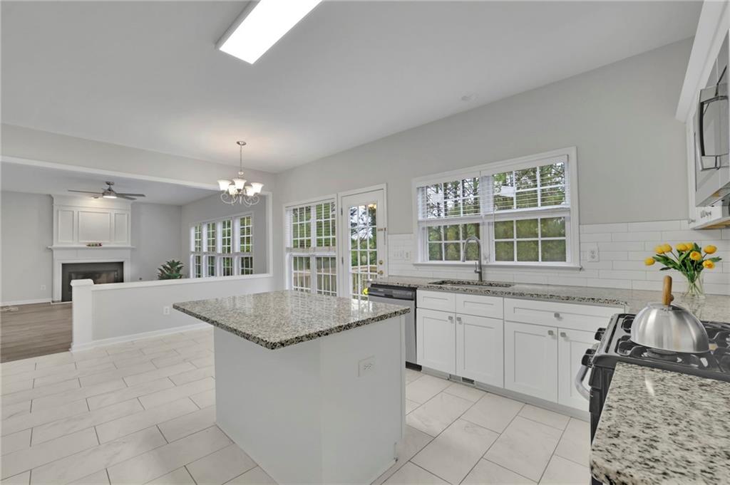 11420 Crossington Road Alpharetta, GA 30005 - Photo 15 of 39 a view of a kitchen with granite countertop lots of counter top space and windows