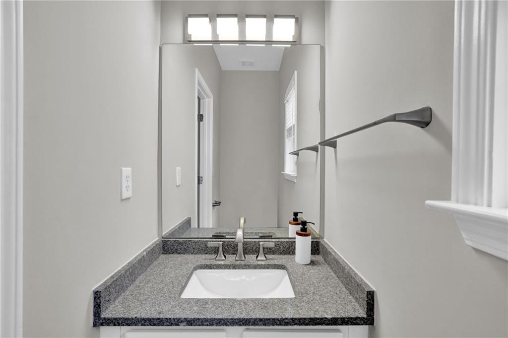 11420 Crossington Road Alpharetta, GA 30005 - Photo 18 of 39 a bathroom with a granite countertop sink and a mirror