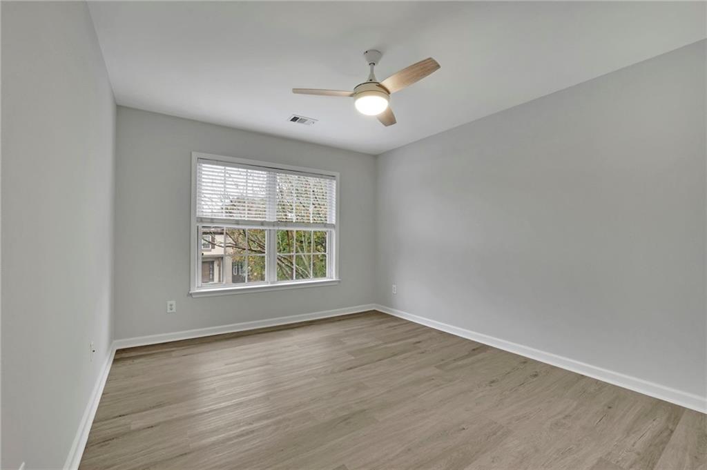 11420 Crossington Road Alpharetta, GA 30005 - Photo 21 of 39 an empty room with wooden floor and windows