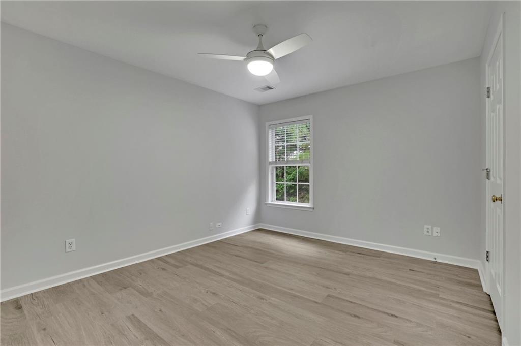 11420 Crossington Road Alpharetta, GA 30005 - Photo 23 of 39 an empty room with wooden floor and windows