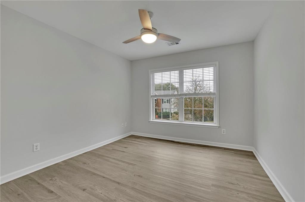 11420 Crossington Road Alpharetta, GA 30005 - Photo 24 of 39 an empty room with wooden floor and windows