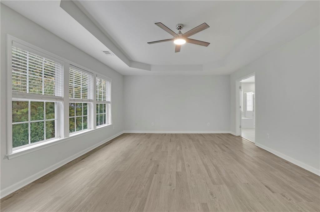 11420 Crossington Road Alpharetta, GA 30005 - Photo 25 of 39 a view of an empty room with wooden floor and a window