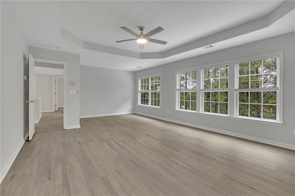 11420 Crossington Road Alpharetta, GA 30005 - Photo 26 of 39 a view of an empty room with a window and wooden floor
