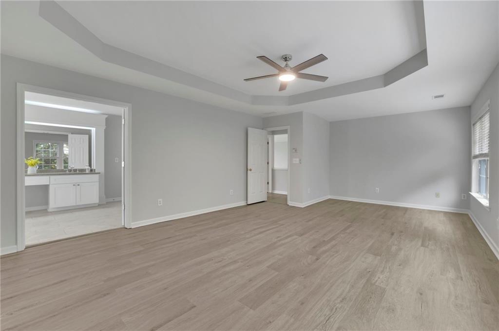 11420 Crossington Road Alpharetta, GA 30005 - Photo 27 of 39 a view of an empty room with wooden floor and a window