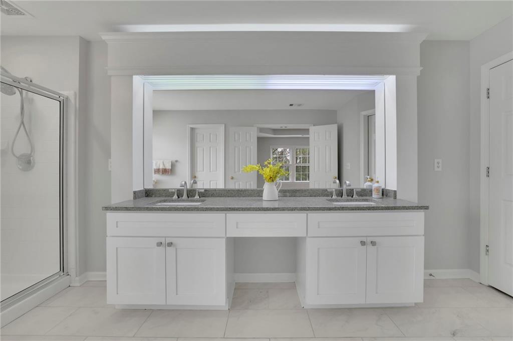 11420 Crossington Road Alpharetta, GA 30005 - Photo 29 of 39 a bathroom with a sink and a mirror