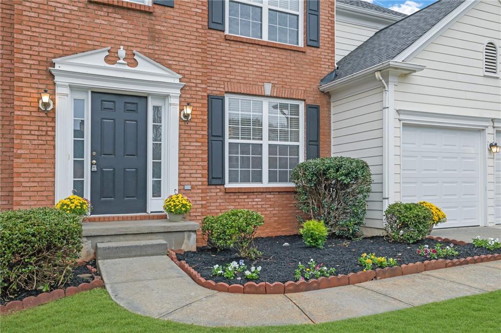 11420 Crossington Road Alpharetta, GA 30005 - Photo 3 of 39 a front view of a house with garden