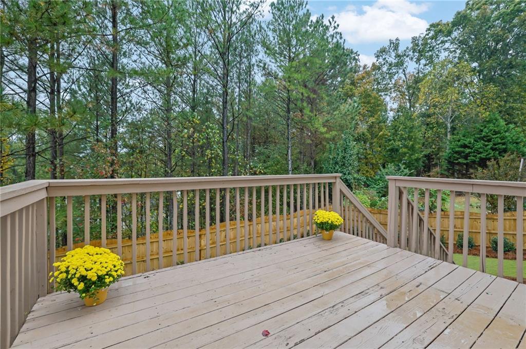 11420 Crossington Road Alpharetta, GA 30005 - Photo 34 of 39 a view of a wooden deck with a bench