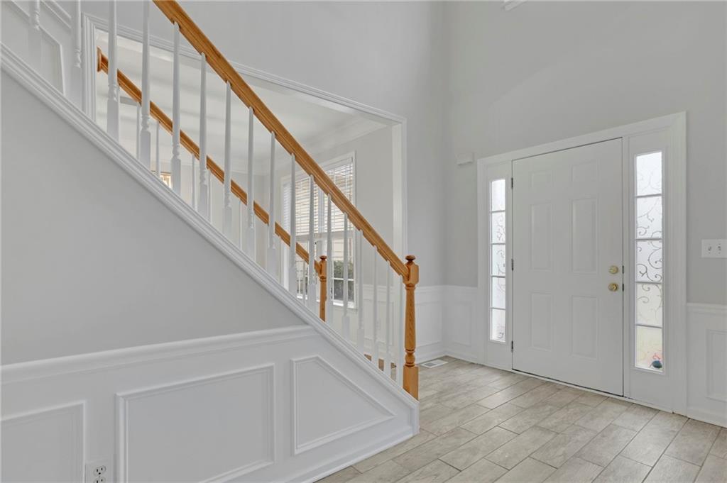 11420 Crossington Road Alpharetta, GA 30005 - Photo 5 of 39 a view of staircase with railing and white walls