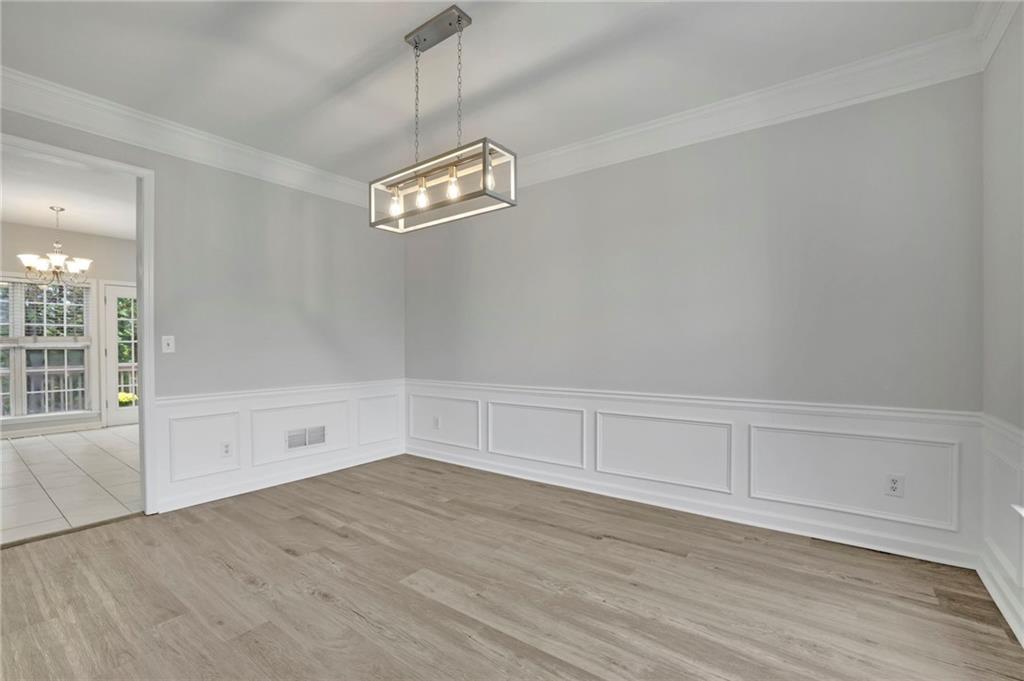 11420 Crossington Road Alpharetta, GA 30005 - Photo 7 of 39 a view of empty room with wooden floor and fan