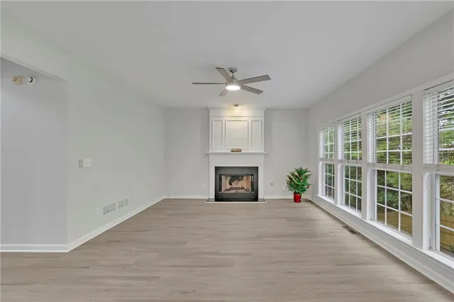 a large white kitchen with cabinets