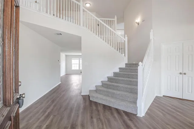 a view of entryway and hall with wooden floor