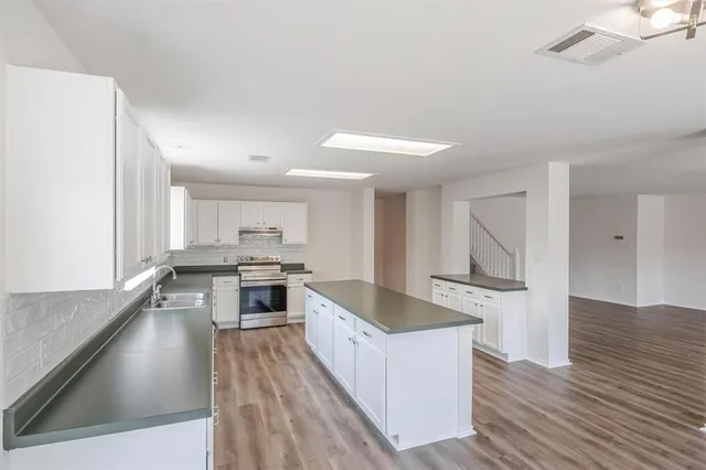 a large kitchen with a stove and a sink