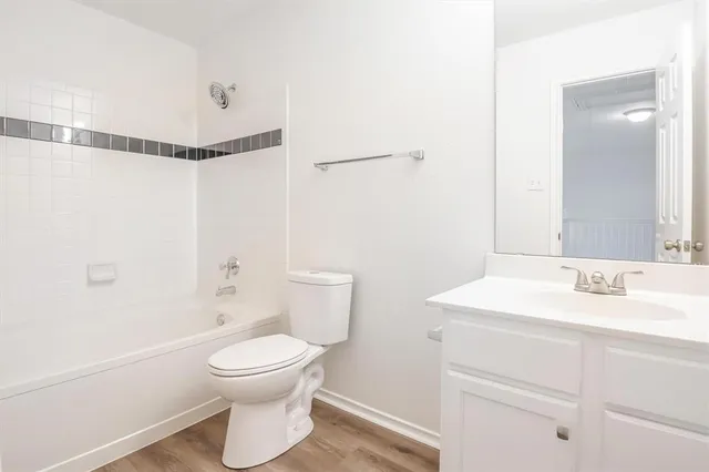 a bathroom with a toilet sink a mirror and shower