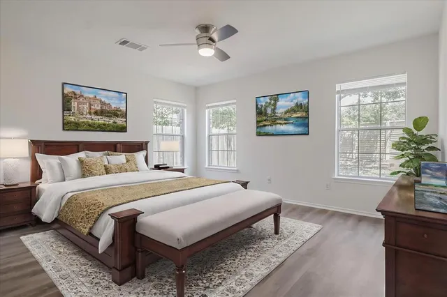 a spacious bedroom with a bed and a window