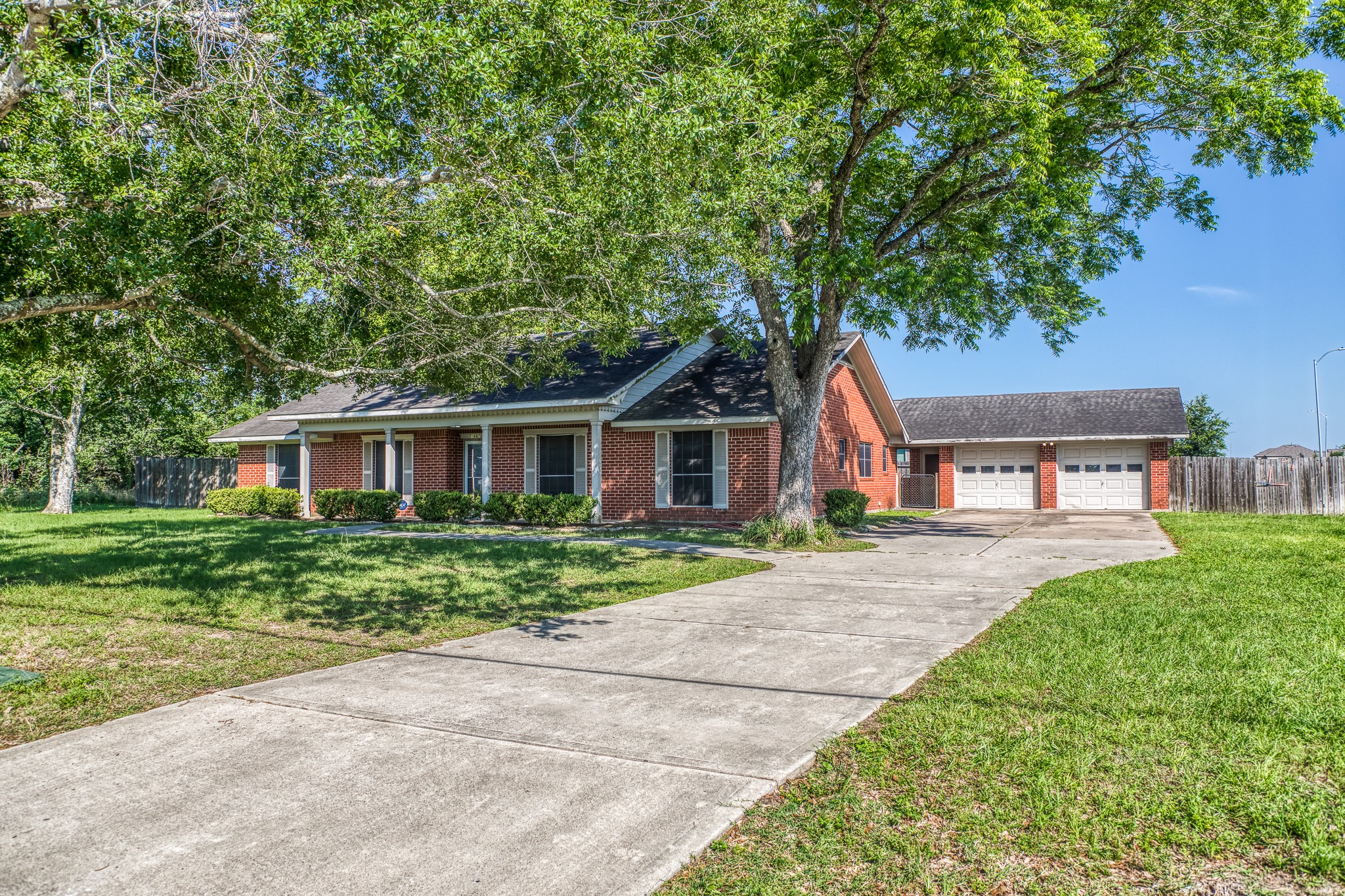 1687 Eagle Lake Road Sealy, TX 77474 - Photo 1 of 27 a front view of a house with a garden