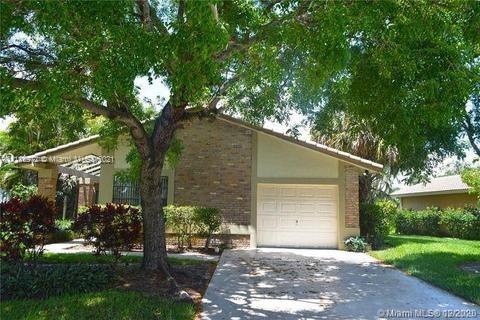 19625 Back 9 Drive Boca Raton, FL 33498 - Photo 2 of 13 a front view of a house with a yard and garage
