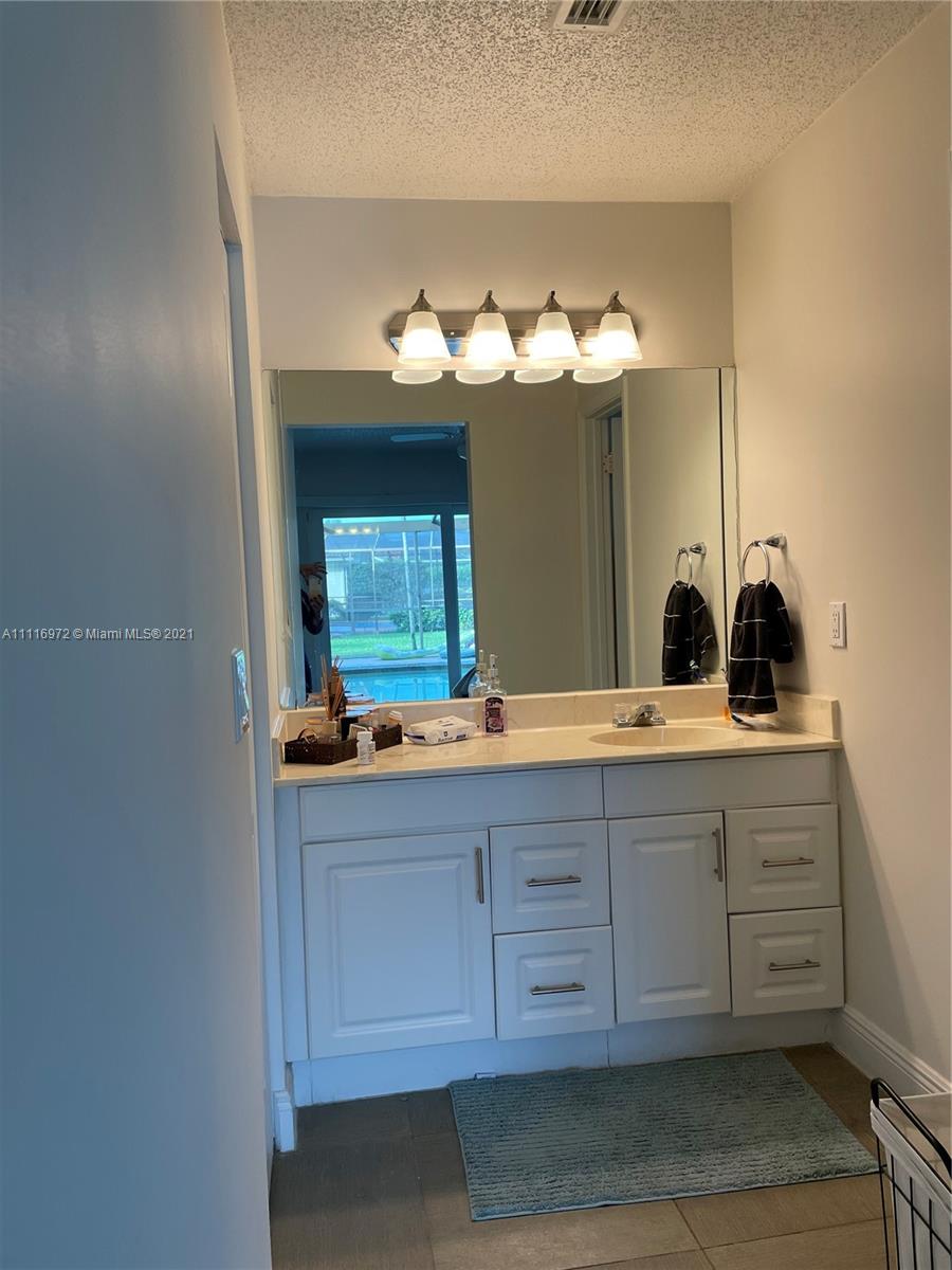 19625 Back 9 Drive Boca Raton, FL 33498 - Photo 11 of 13 a bathroom with a double vanity sink and a mirror