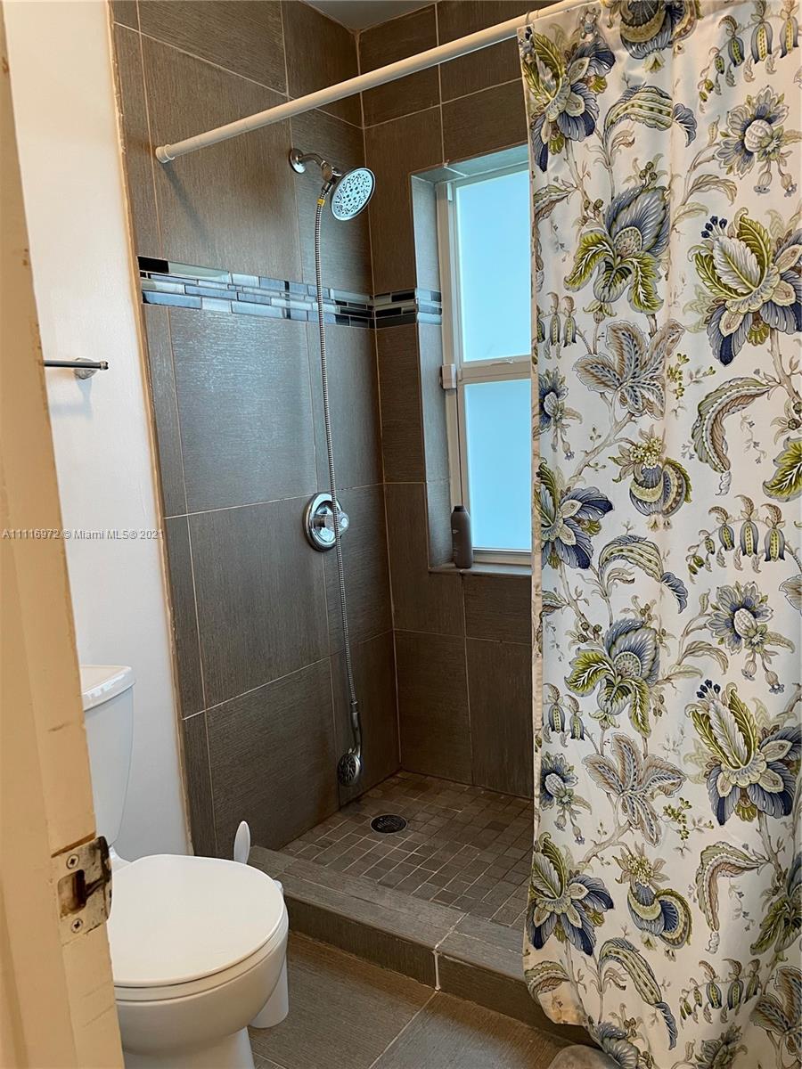 19625 Back 9 Drive Boca Raton, FL 33498 - Photo 12 of 13 a bathroom with a shower and toilet