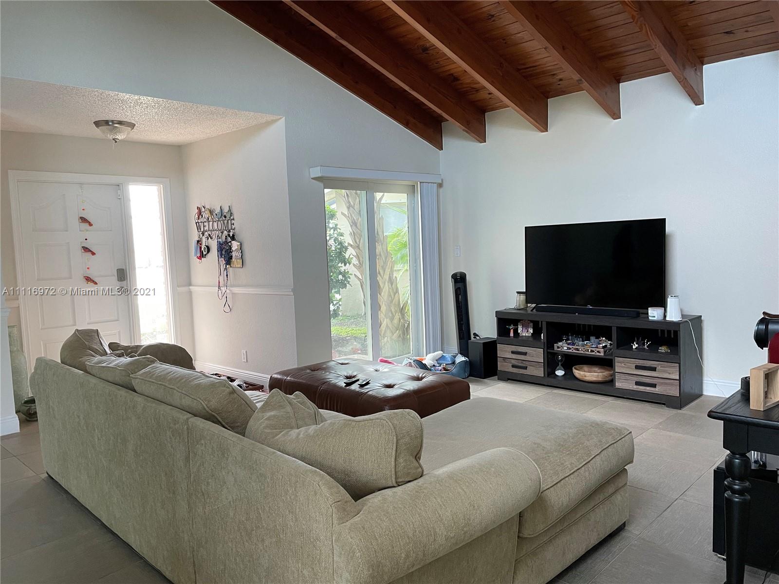 19625 Back 9 Drive Boca Raton, FL 33498 - Photo 4 of 13 a living room with furniture and a flat screen tv