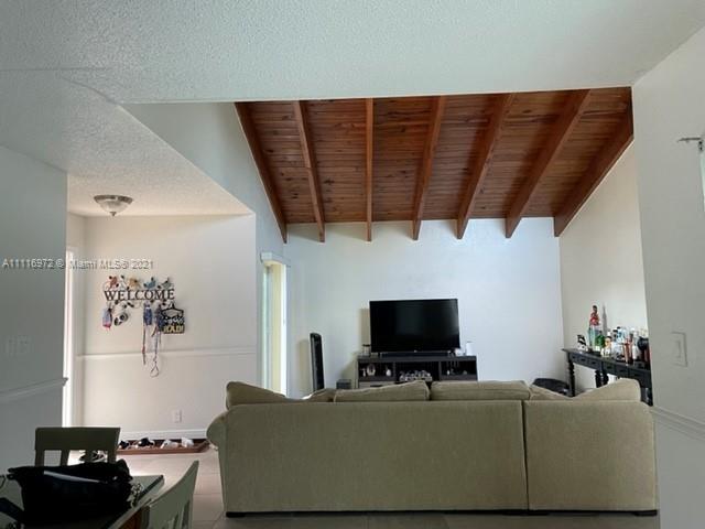 19625 Back 9 Drive Boca Raton, FL 33498 - Photo 5 of 13 a living room with furniture and a flat screen tv