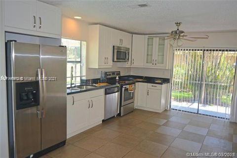 19625 Back 9 Drive Boca Raton, FL 33498 - Photo 6 of 13 a kitchen with a refrigerator sink and cabinets
