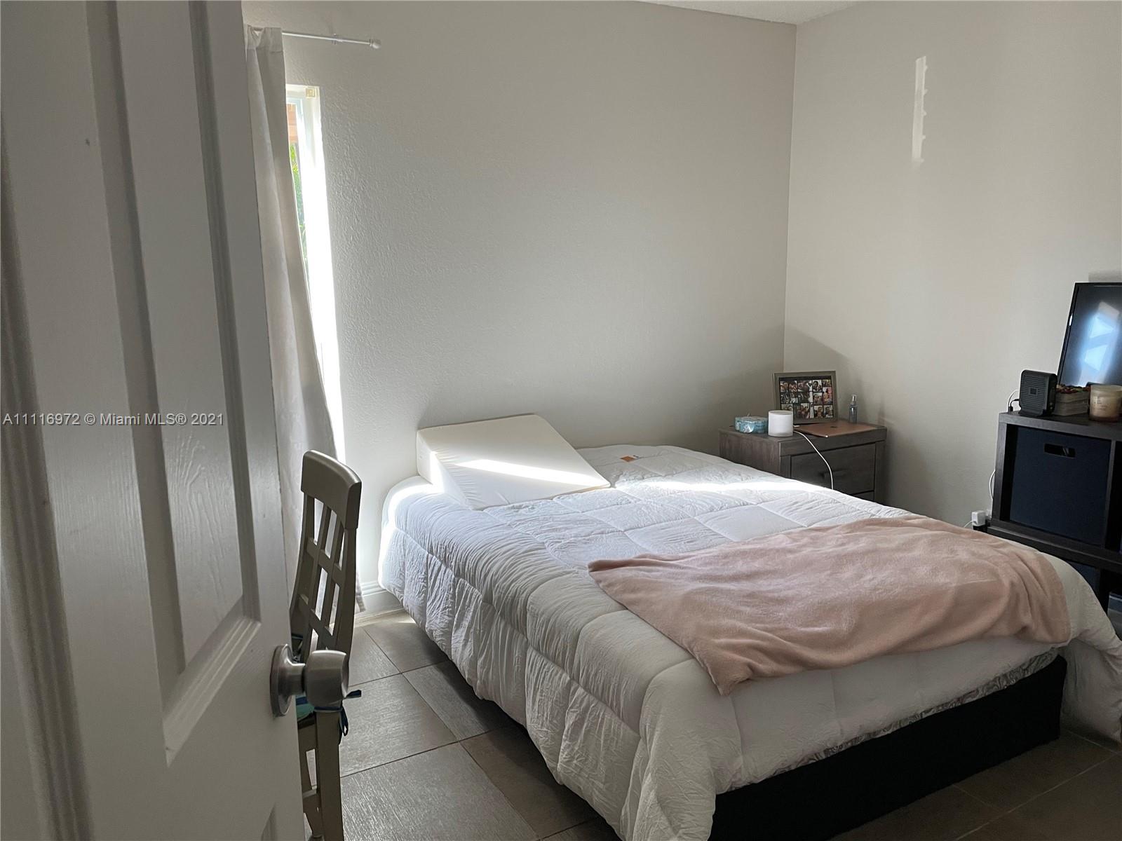 19625 Back 9 Drive Boca Raton, FL 33498 - Photo 7 of 13 a bedroom with a bed and wooden floor
