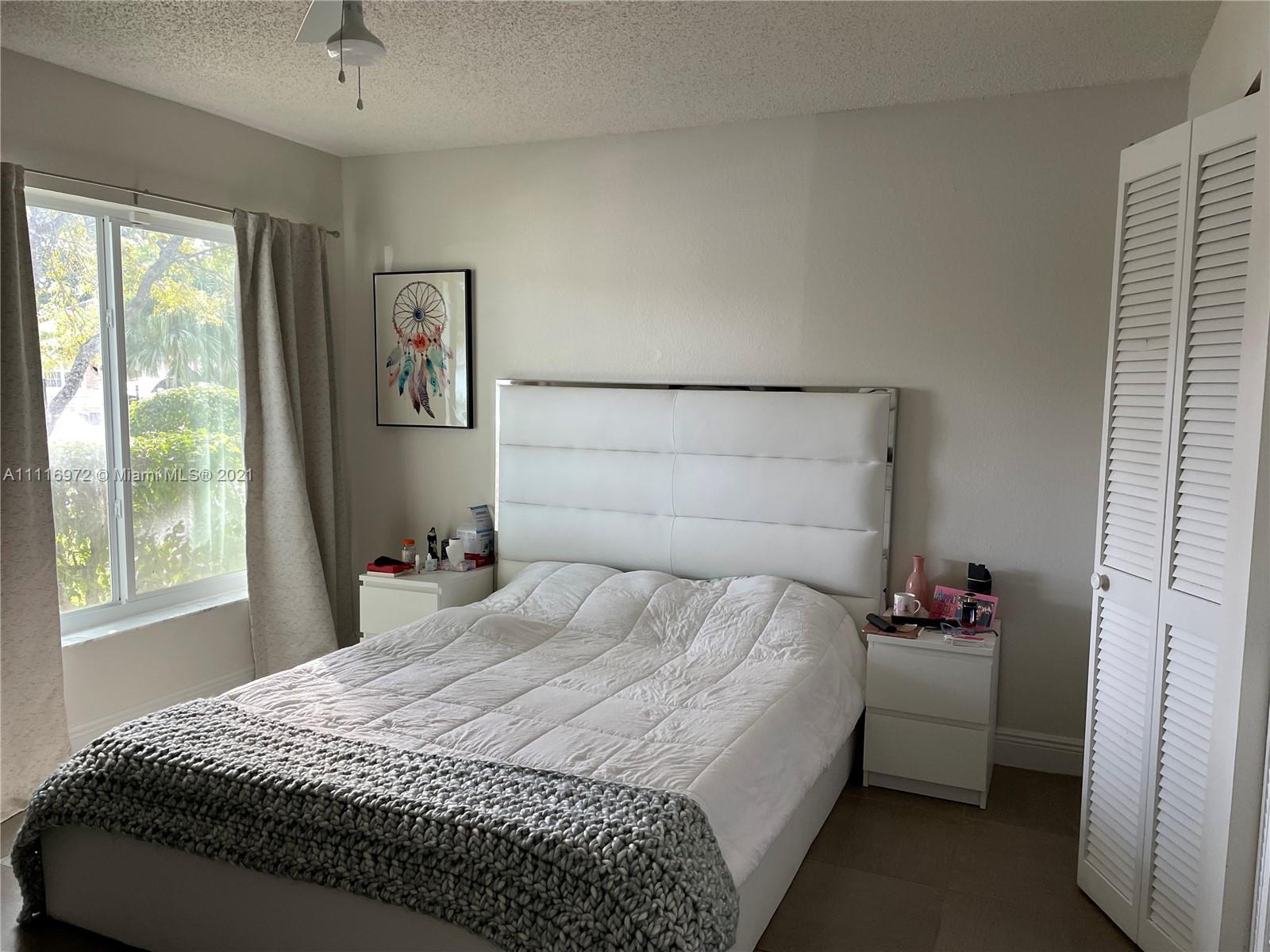 19625 Back 9 Drive Boca Raton, FL 33498 - Photo 8 of 13 a bedroom with a bed and a window