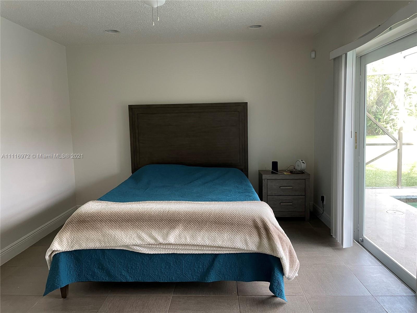 19625 Back 9 Drive Boca Raton, FL 33498 - Photo 9 of 13 a bedroom with a bed and window