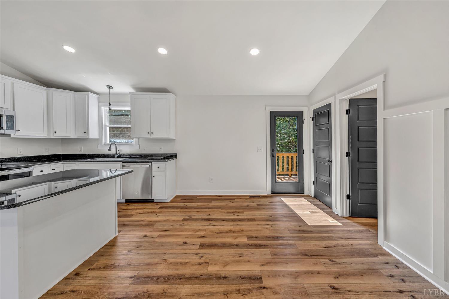 1484 White House Road Moneta, VA 24121 - Photo 11 of 27 a large kitchen with granite countertop a stove and a sink