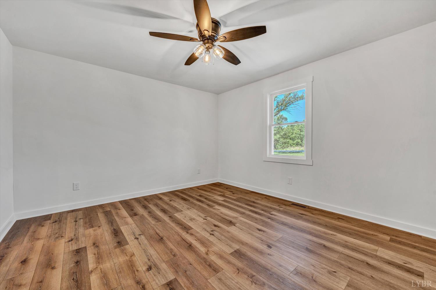 1484 White House Road Moneta, VA 24121 - Photo 12 of 27 an empty room with windows and fan