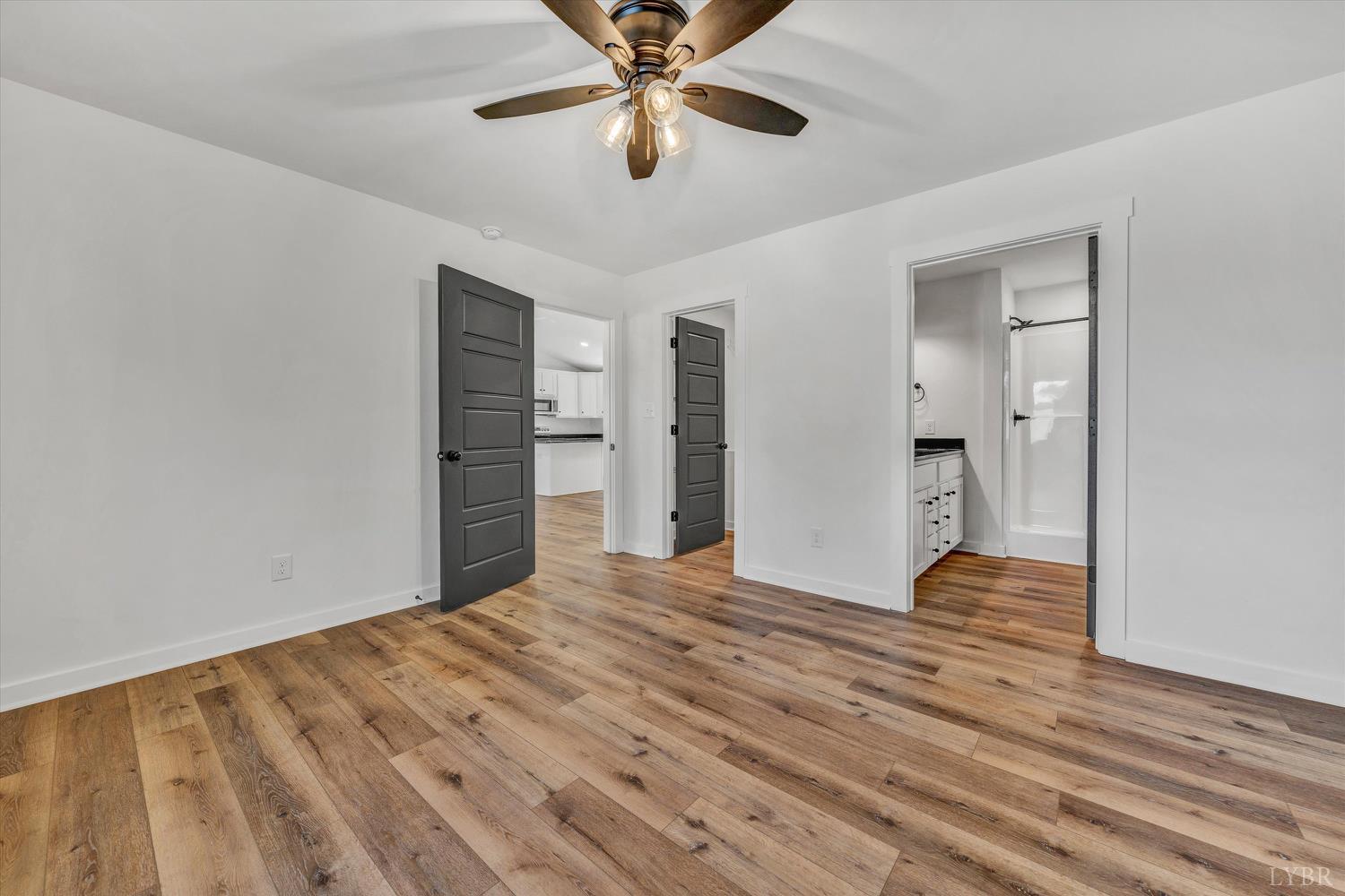 1484 White House Road Moneta, VA 24121 - Photo 13 of 27 a view of an empty room with wooden floor and a ceiling fan