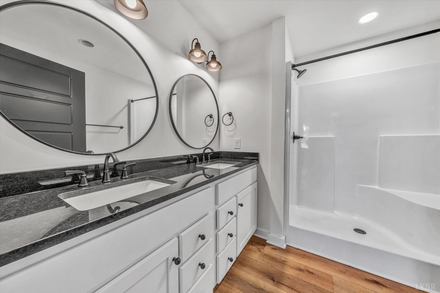 1484 White House Road Moneta, VA 24121 - Photo 14 of 27 a bathroom with a double vanity sink mirror and shower