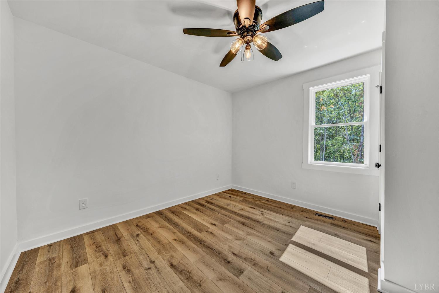 1484 White House Road Moneta, VA 24121 - Photo 20 of 27 an empty room with a window and a ceiling fan