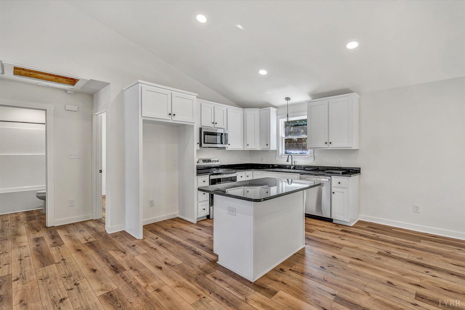 1484 White House Road Moneta, VA 24121 - Photo 7 of 27 a kitchen with stainless steel appliances granite countertop a stove and a refrigerator
